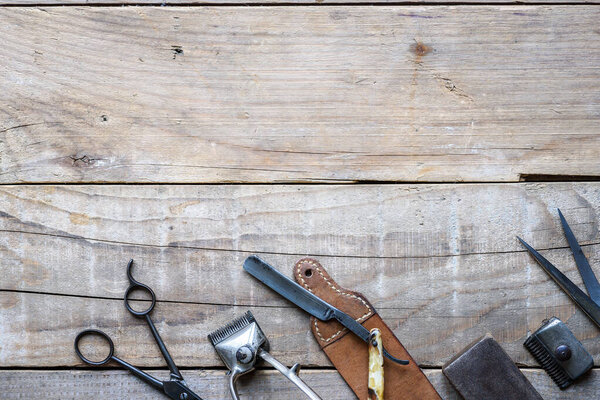 set of barber tools on wooden background 