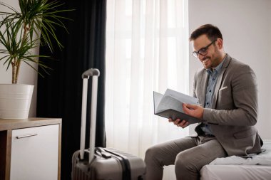 İş seyahati. Zarif iş adamı otel odasında çalışıyor.