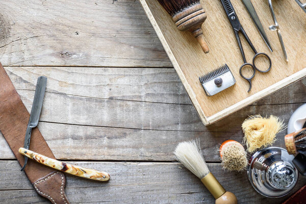 set of barber tools on wooden background