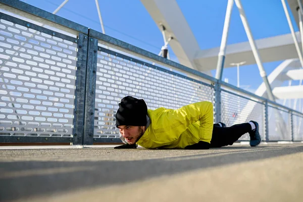 Young Athlete Man Stretching His Muscles Running Bridge Sunny Winter — Stock Photo, Image