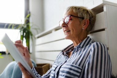 Güzel Olgun kadın evde tablet kullanma