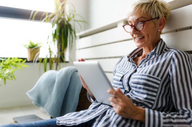 Güzel Olgun kadın evde tablet kullanma