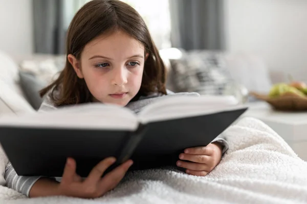 Beautiful Little Girl Reading Book Sofa — Stock Photo, Image