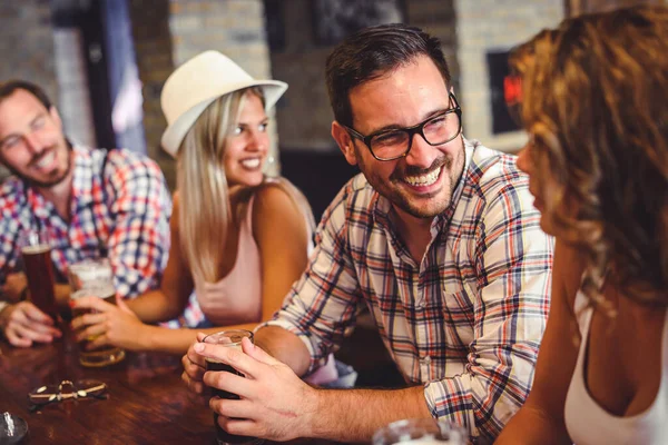 stock image cheerful friends spending time in bar, drinking beer