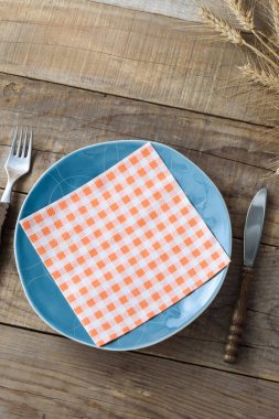 Kırsal ahşap masada mavi bıçak ve çatal. Yemek arkaplanı