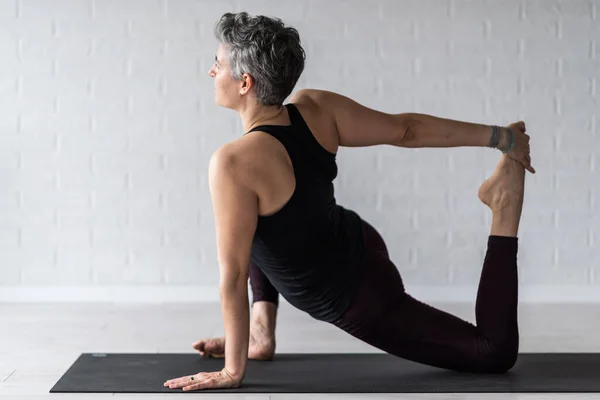 stock image mature woman doing yoga