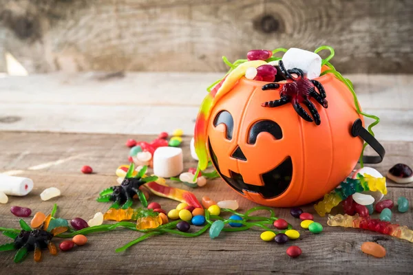 Halloween candies on wood table - holiday background