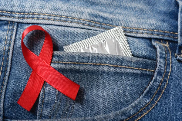 Red Ribbon Blue Denim Condom Pocket — Stock Photo, Image