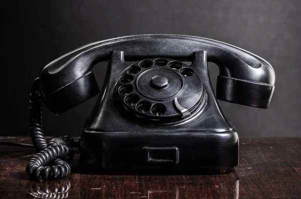 stock image old vintage telephone on wooden table 