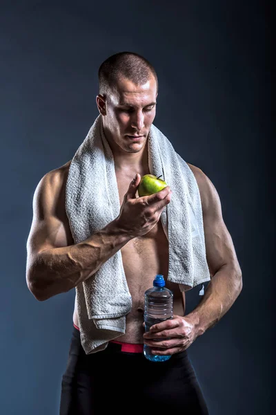 ワークアウト後に水とリンゴとタオルを持つ男性アスリート — ストック写真