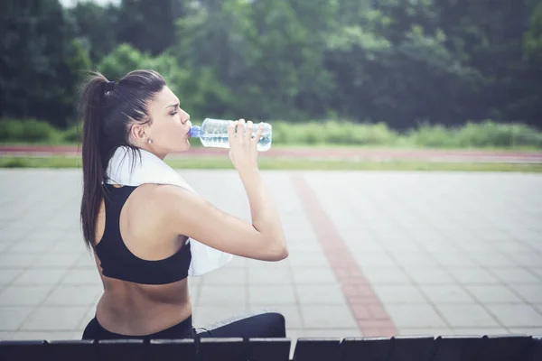 stock image Sport Girl Sitting On The Bench, Drinking Water