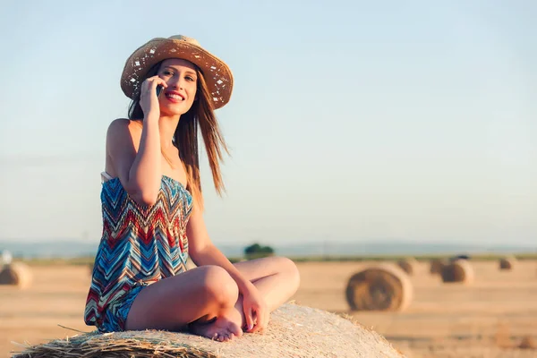 stock image beautiful young woman in field with phone