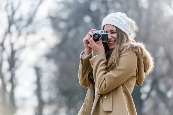 stock image Portrait of winter girl taking photo with vintage camera