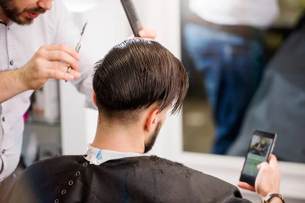 Men Barber Shop Using Smart Phone While Having Haircut — Stock Photo, Image