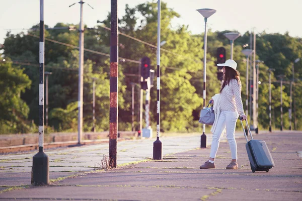 stock image Young woman with baggage walking in sunlight. Travel background.