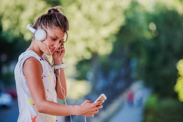 stock image portrait of young attractive woman listening music outdoor