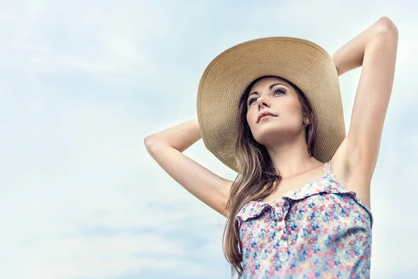 stock image beautiful woma in  straw hat posing in a summer day.