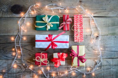 christmas gift boxes with gifts on wooden background