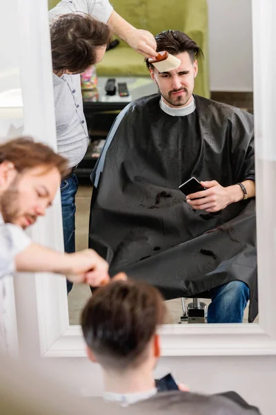 Men Barber Shop Using Smart Phone While Having Haircut — Stock Photo, Image