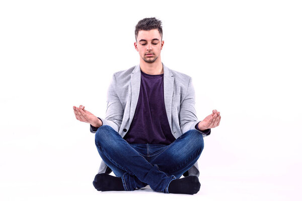 Young Businessman Meditating Isolated on White background 