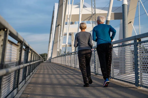 senior couple running in city