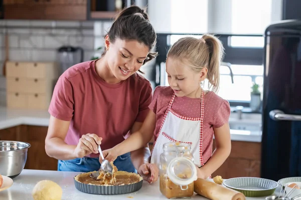 stock image happy mother and daughter preparing pie together in kitchen