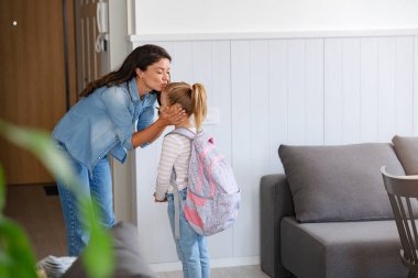 Çocuk okula geri dönüyormuş. Anne ve çocuk ilk okul günü için hazırlanıyorlar. Küçük kız ve anne okula gidiyor.