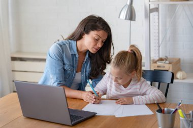 Mutlu anne ve kız evde birlikte okuyorlar, online eğitim alıyorlar.