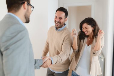 Adam ve hamile karısı, bir emlakçıyla konuşuyorlar. Satılık ya da kiralık bir daireyi ziyaret ediyorlar. Müstakbel ebeveynler daire alıyor. Emlak kavramı