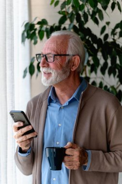 Cep telefonu ve bir fincan kahvesi olan son sınıf öğrencisi.