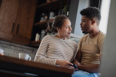 Mutfakta oturmuş sohbet eden bir çift.