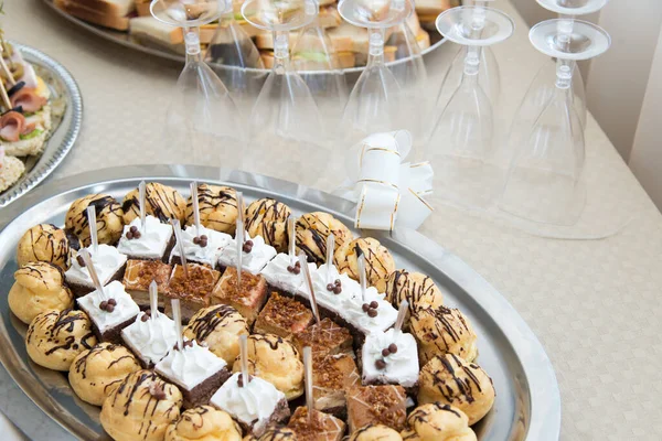 Catering sweets, close up of various kinds of cakes on event or wedding reception  - selective focus