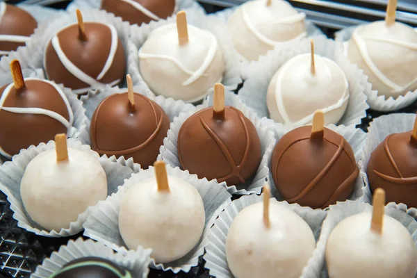 Catering sweets, close up of various kinds of white and brown chocolate balls on event or wedding reception  - selective focus