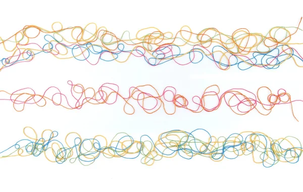 Tangled colorful cotton threads isolated on white background. Abstract thread lines pattern.