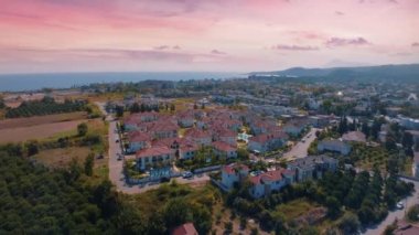 Hava aracı video görüntüleri. Tatil köyünün panoramik manzarası dağların arka planına karşı. Şehrin en iyi manzarası. Yüksek kalite 4k görüntü