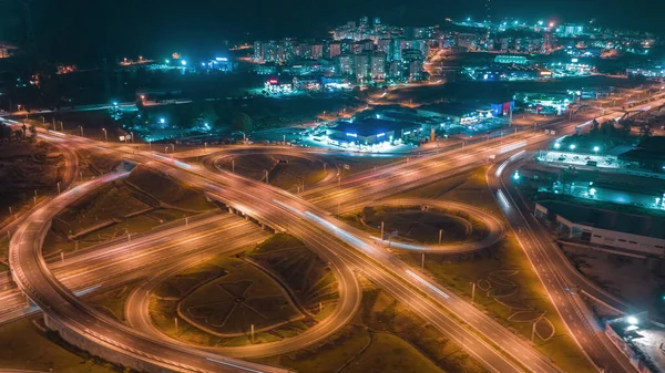 Flying around a multi-level stack interchange. Aerial drone view . Blue yellow light. Fast moving. Photography. High quality photo