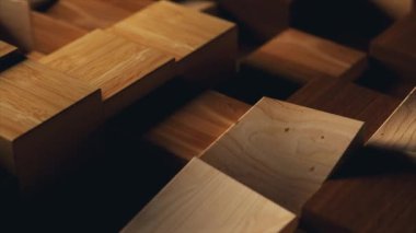 Wooden square figures randomly rise and fall. Shadow. Close-up. Dynamic geometric objects. Steps. Lighting. High quality 4k footage