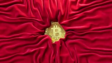 Satin red fabric crinkles around the gold bitcoin. Cryptocurrency concept. Silk. Creases in fabric. Drapery. High quality 4k footage