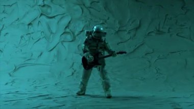 Astronaut musician plays the guitar on the background of a limestone wall. Purple neon lighting. Universe Disco Party. 3d animation of a seamless loop. High quality 4k footage