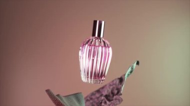 Bej bir arka planda kozmetik parfüm şişesi. Kokulu kozmetik ürünü. Her yerde ipek kumaş var. Çiçek özü. Üç boyutlu animasyon. Yüksek kalite 4k görüntü