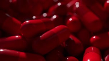 Parlak kırmızı kapsüllere yakın çekim, tıbbi ve sağlık animasyonu için ideal..