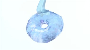 Mavi sıvı parlak yüzeyi olan kristal mavi bir çöreğin üzerine dökülüyor.