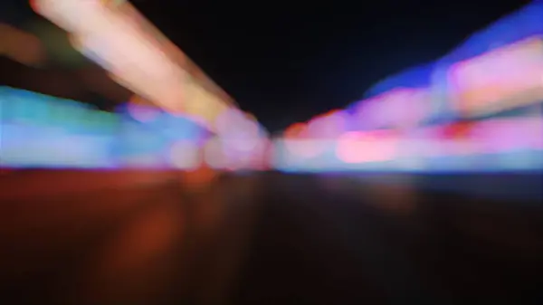 stock image Dynamic 3D animation of neon lights in a cityscape, featuring a fast-paced, blurred motion effect. Perfect for showcasing futuristic urban environments.