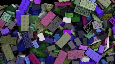 Değişik şekil ve boyutlarda renkli plastik tuğlalar siyah bir arkaplana doğru düşüyor ve yavaş yavaş yığılıp yığılıyor.