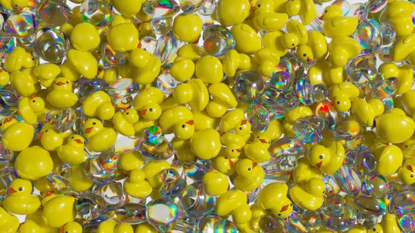 Sarı kauçuk ördekler el değmemiş beyaz yüzeye dökülüyor. Çerçeveyi şeffaf yanardöner kürelerle dolduruyorlar. Çocukluk kaprislerinin neşeli görsel öyküsünü yaratıyorlar.