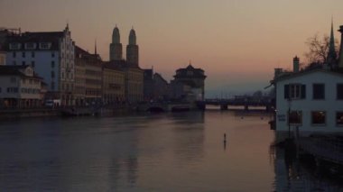 Günbatımında Zürih 'in eski kasabasındaki Limmat Nehri üzerindeki köprü. Yüksek kalite 4K görüntü