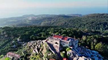 Portekiz 'deki Sintra Cascais Doğal Parkı' ndaki uçurumun tepesinde Peninha Sığınağı 'nı çevreleyen insansız hava aracı. Yüksek kalite 4k görüntü