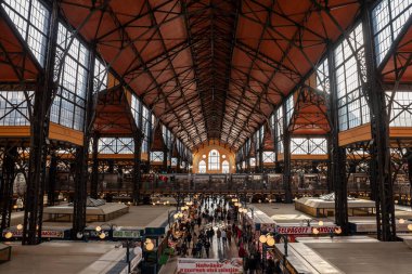 BUDAPEST, HUNGARY - FEBRUARY 26, 2022: Aerial panorama of the interior of the market of Nagyvasarcsarnok, the great Market hall of Budapest, with a crowd passing by stalls shop stand