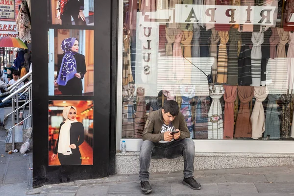 Istanbul Turkey 2022年5月21日 イスラム教徒の服 イスラム教徒のスカーフやベールを販売店の前でスマートフォンの携帯電話を使用して男 — ストック写真