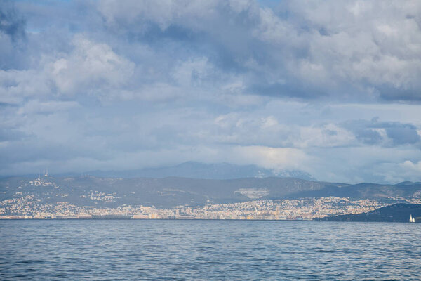 Panorama of the city of Trieste and its port, seen from afar, from the Adriatic Sea. Trieste is an italian city of the Friuli Venezia Giulia province